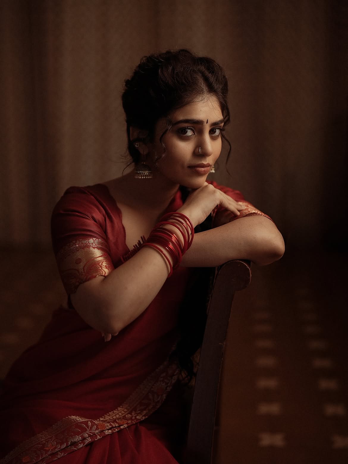 Bandhavi Sridhar Poses With Bangles In Red Saree