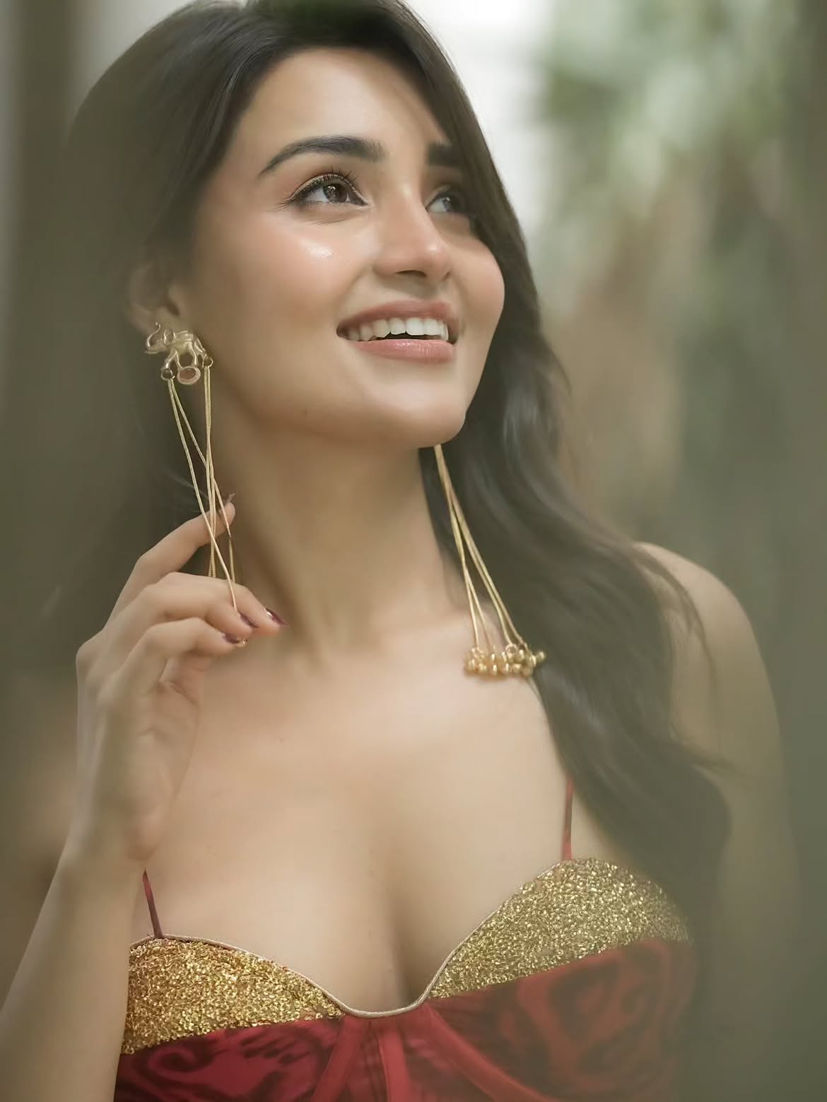 Dharshna Sripal Smiles In A Shimmery Red Outfit