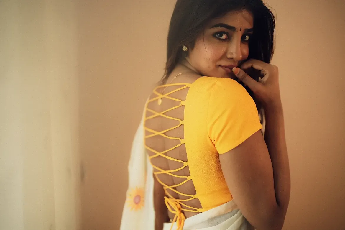 Draped In White Saree With Playful Sharp Glance