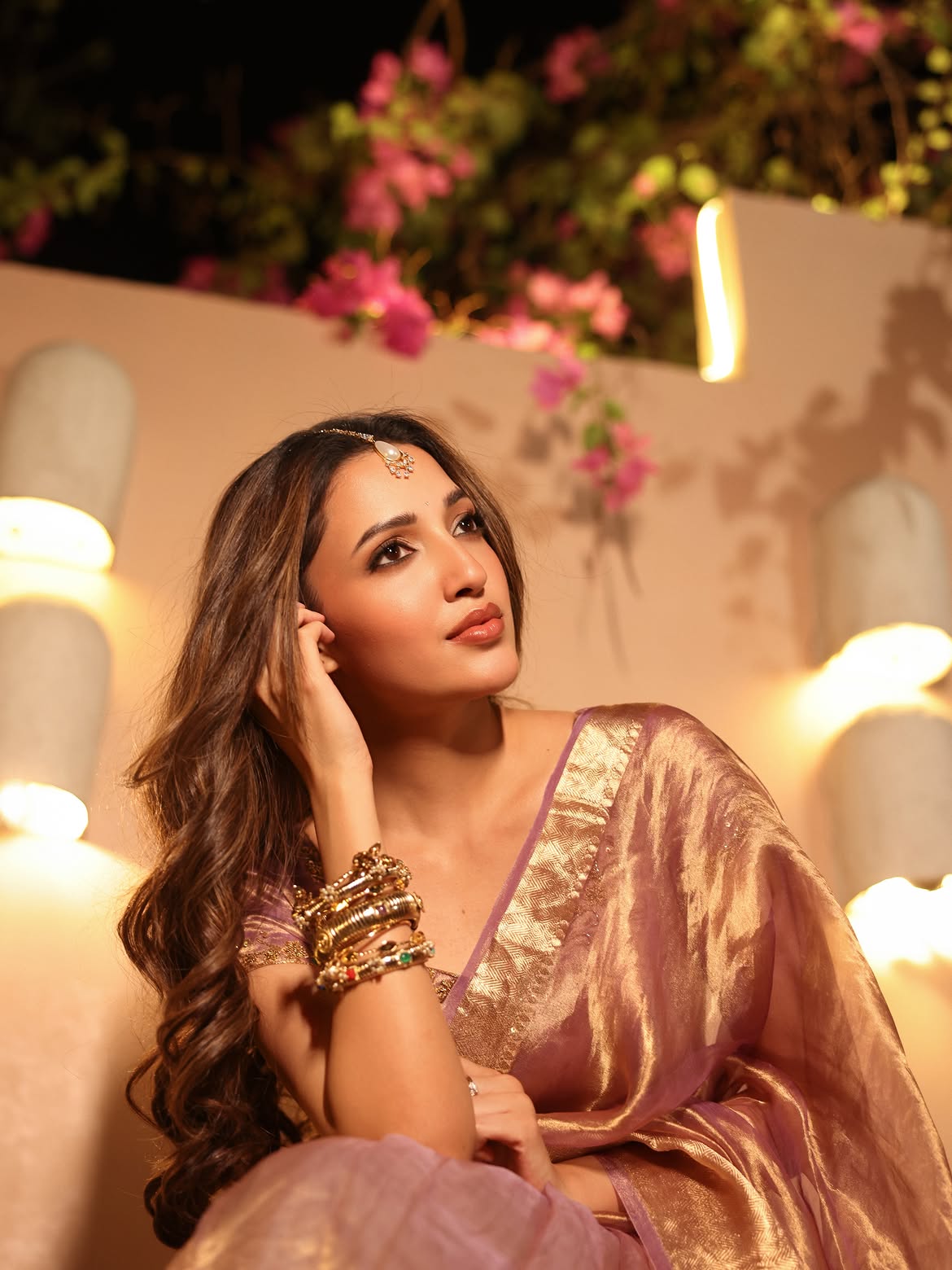 Neha Shetty Poses With Bangles In A Golden Saree