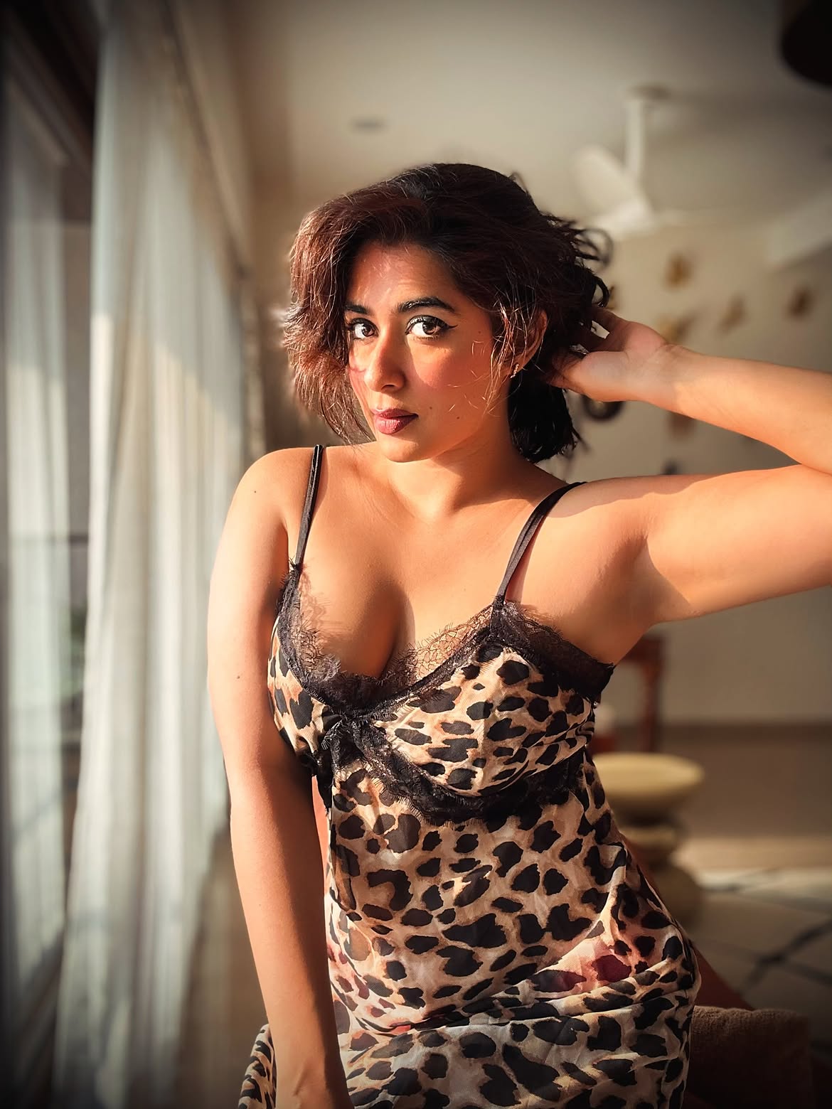 Nikita Sharma Looks At Camera In A Leopard Dress