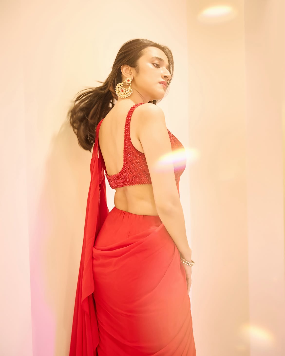 Nuveksha Looks Back In A Red Saree Studio Shoot!
