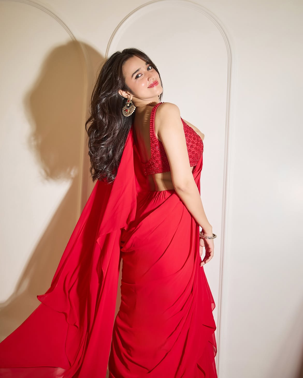 Nuveksha Gives A Soft Smile In Bright Red Saree!